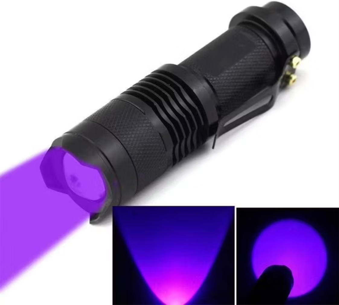 Black UV flashlight emitting purple light on a white background
