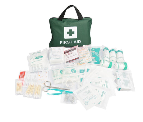 First aid kit with various supplies on a white background